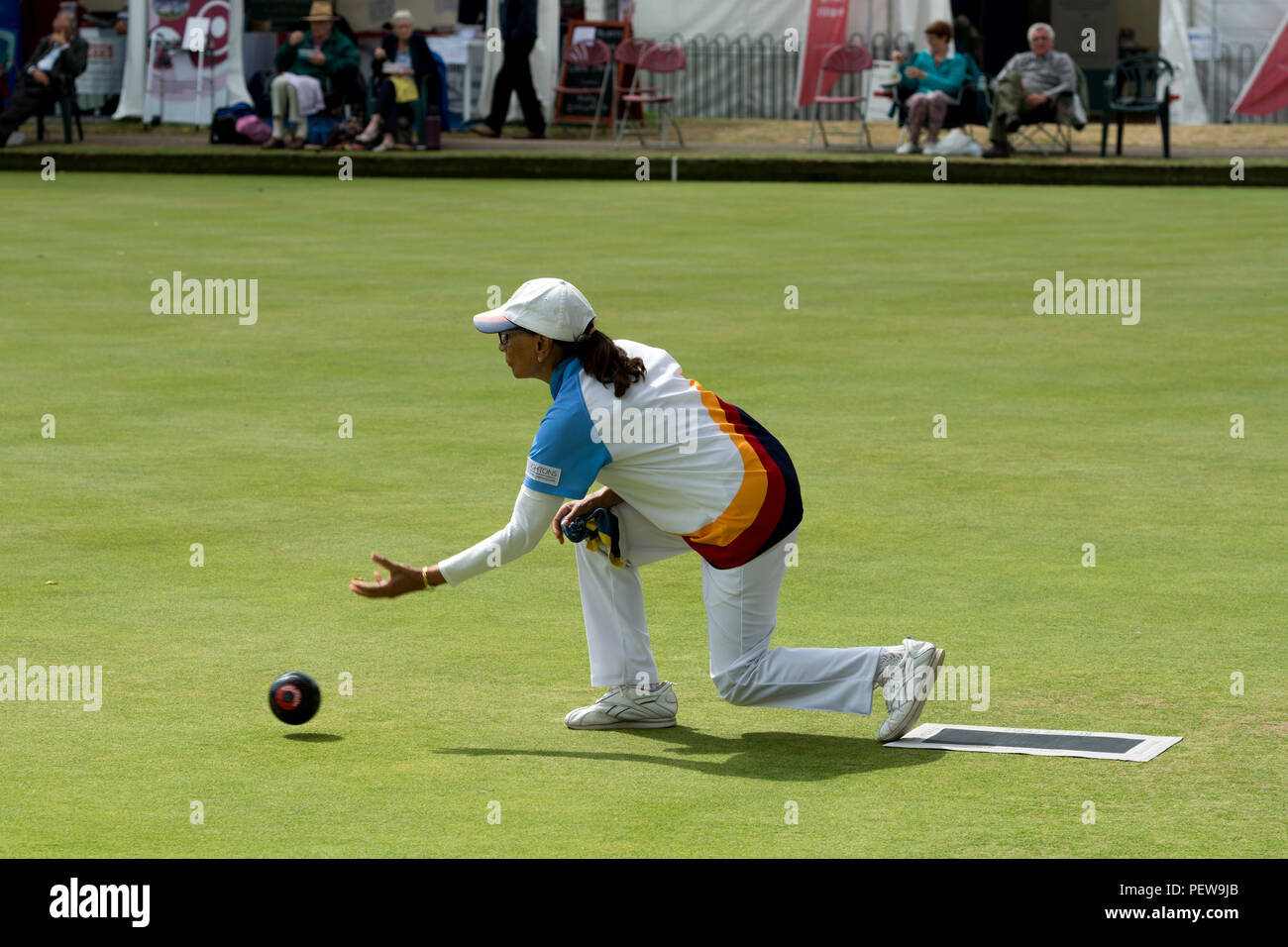 A player bowling a wood at the national women`s lawn bowls championships, Leamington Spa, UK Stock Photo